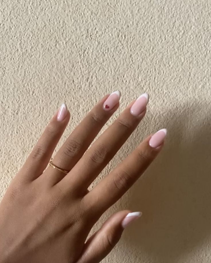 French nails with heart French Mani With Heart, Heart French Nail, Heart On French Tip Nails, Oval Nails With Hearts, French Tip Nails Almond With Heart, Small Heart Nails Simple, Wedding Nails For Bride Heart, French Tips With Small Heart, White French With Red Heart