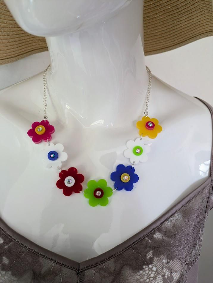 Spring Flower Statement Fun Necklace to brighten up any occasion. This very cheerful and happy necklace is: Laser made from High Quality 3mm Acrylic using several cheerful colors and finished with a diamante sparkly centre.  The chain length is 30 cms including an extension of 10cms with a charm.  The chain is silver and has a lobster clap. The necklace in made with 7 individual  flower cut pieces. Each flower  is  approx. 28 mm in diameter  Each centre is 10mm and the diamante is 5mm If you wou Flowers Colourful, Laser Cut Acrylic, Cool Necklaces, Spring Flower, Silver Mirrors, Heart Earrings, Wedding Shop, Chain Lengths, Spring Flowers