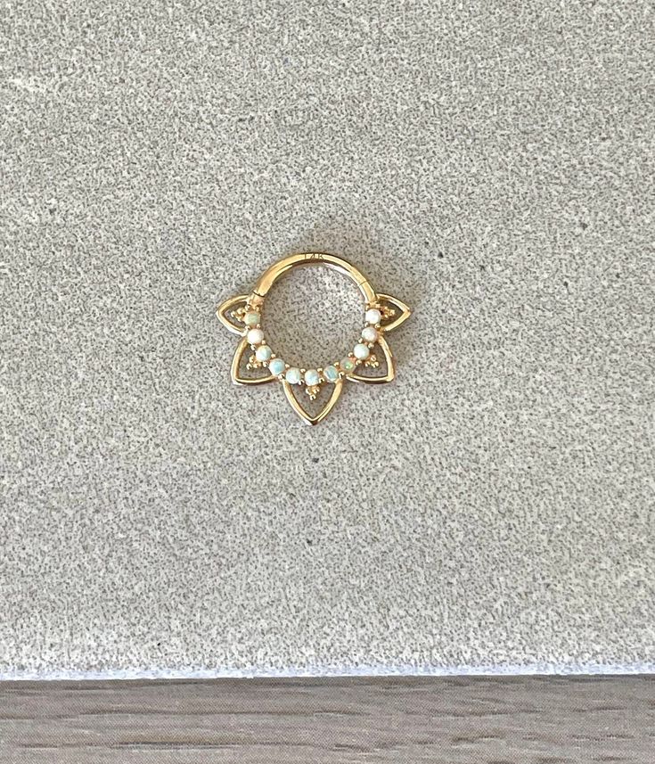 "This solid gold 8mm or 10mm septum piercing ring is made of 14K gold, and has faux opals. Please note that the 10mm size has one extra set of \"spikes\" because of the larger size. Piercing \"clicks\" into place. Super dainty minimalist look - drop jaws with this body jewelry! **Please upgrade to priority shipping at checkout for an additional $3 if you would like to insure your package! I am not responsible for lost, delayed or stolen packages.** Details & Size: ♥ 14k Gold - Yellow or White Go Dainty 14k Gold Septum Ring, Dainty 14k Gold Round Septum Ring, 14k Gold Dainty Round Septum Ring, Gold Septum Ring Tarnish Resistant As A Gift, Gold Tarnish-resistant Septum Ring As Gift, Gold Tarnish Resistant Septum Ring Gift, Minimalist Round Septum Ring For Wedding, Dainty Everyday Septum Ring, Minimalist Wedding Septum Ring