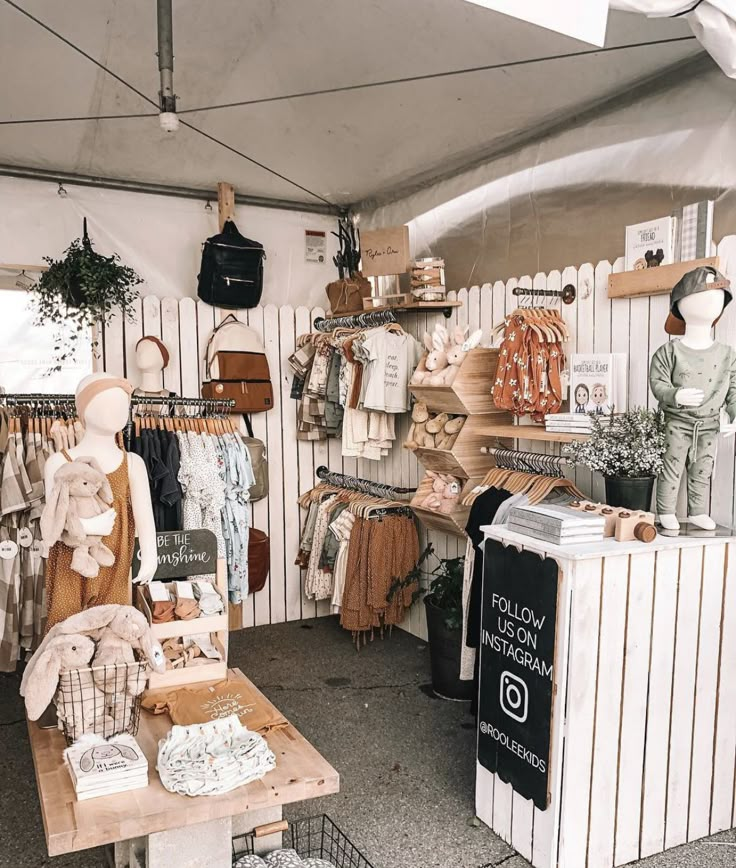 an outdoor clothing store with lots of items on the table and in front of it