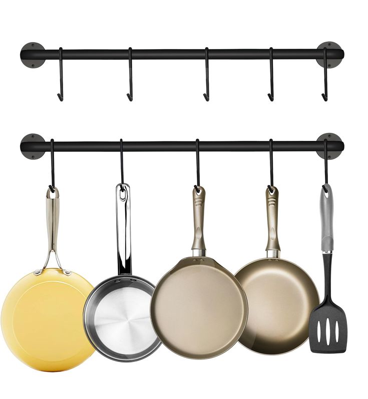 pots and pans are hanging on the wall in this kitchen rack with black hooks