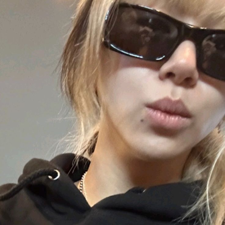 a close up of a person wearing sunglasses