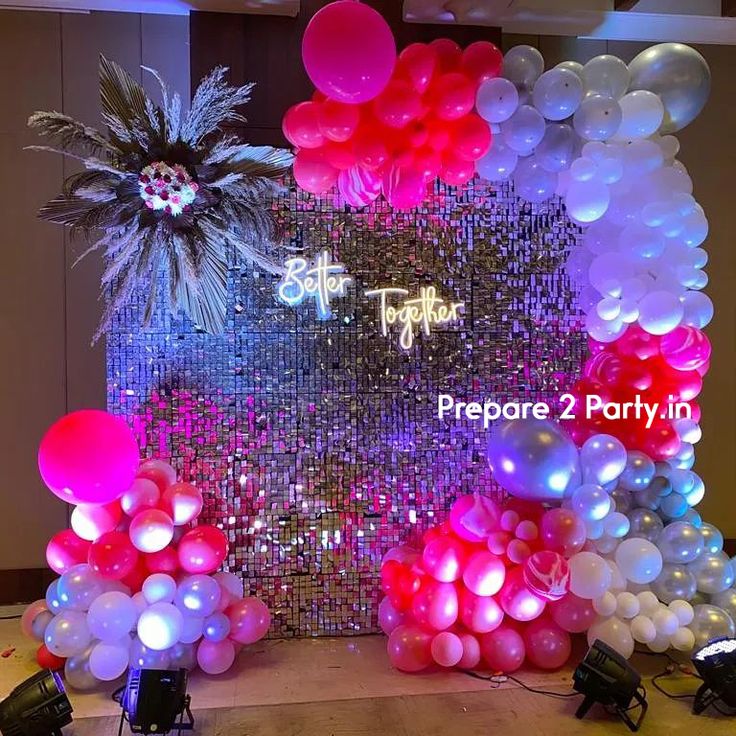 balloons and streamers are set up in front of a backdrop