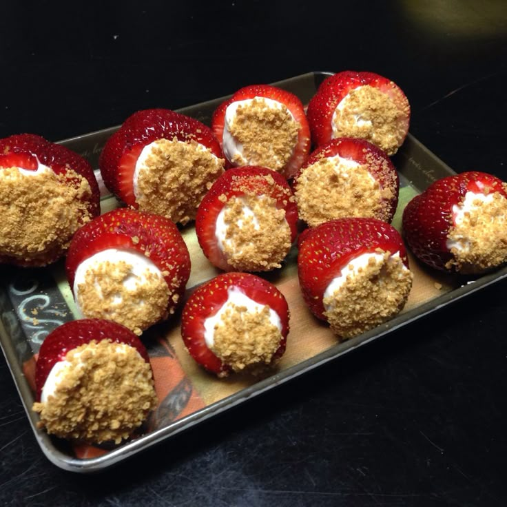 strawberries are arranged on a baking sheet with crumbs