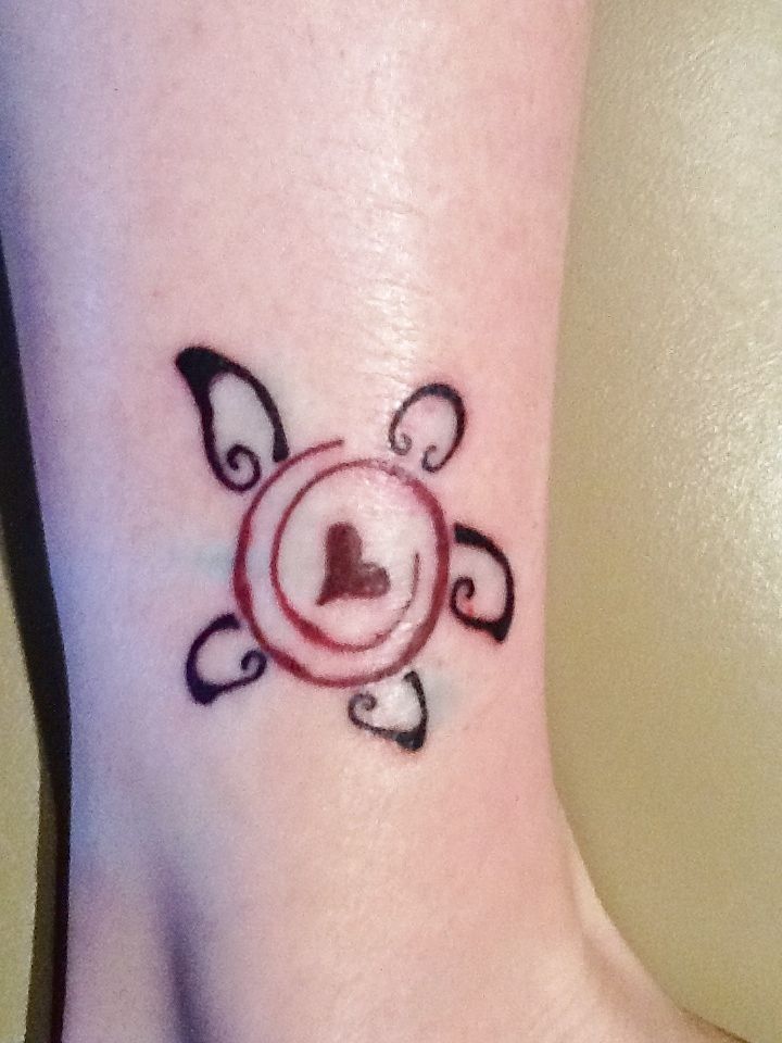 a small tattoo on the ankle of a woman's foot with a lock and heart