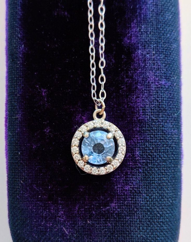 A gorgeous blue sapphire sparkles in the light, accented by a circle of diamonds. Set in 14k white gold, this is the prettiest sapphire necklace you may ever see! Handcrafted in 14k white gold Features a sapphire surrounded by a diamond halo Sapphire measures approx. 5.5mm in diameter Pendant measures approx. 10mm in diameter Full necklace hangs at 18" with a 14k lobster clasp Sapphire Necklaces With Halo Setting, Formal Jewelry With Halo Design And Lab-created Sapphire, Elegant Blue Jewelry With Halo Design, Formal Sapphire Jewelry With Halo Detail, Formal Sapphire Jewelry With Halo, Formal Sapphire Halo Jewelry, Sapphire Jewelry With Brilliant Cut Round Stone, Sapphire Jewelry With Halo Design And Round Cut, Sapphire Jewelry With Halo Design