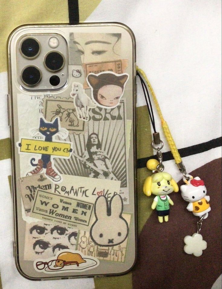 an iphone case with some stickers on it and a keychain attached to it