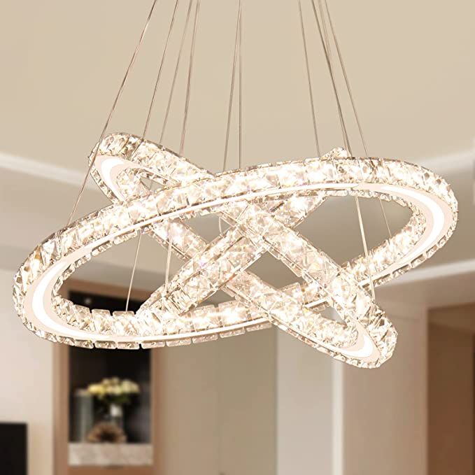 a modern chandelier hanging from the ceiling in a living room or dining room