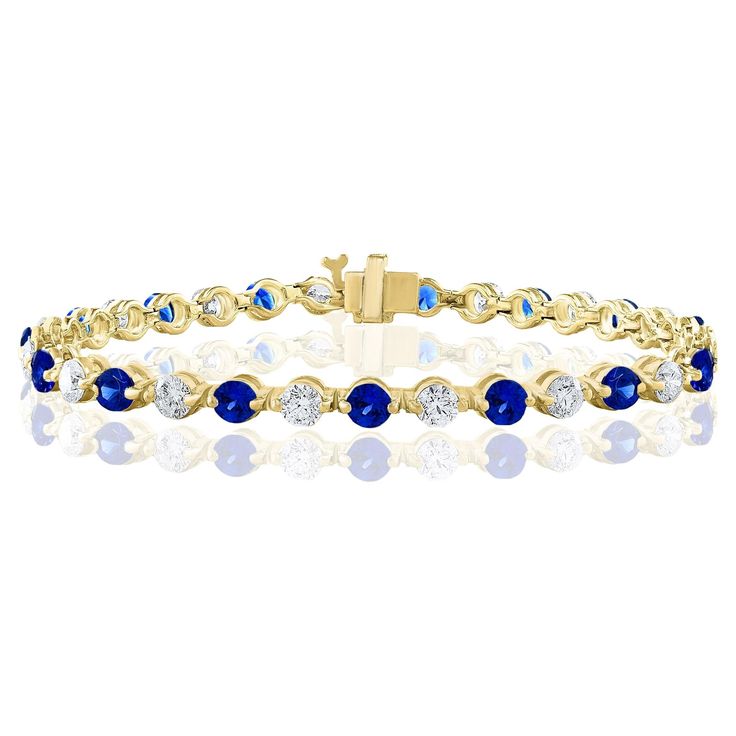 A stunning bracelet set with 18 stunning Blue sapphires weighing 3.18 carat total. Alternating these Blue Sapphires are 18 sparkling round diamonds weighing 2.88 carats in total. Set in polished 14k yellow gold. Double lock mechanism for maximum security. A simple yet dazzling piece. All diamonds are GH color SI1 Clarity. Style is available in different price ranges. Prices are based on your selection. Don't hesitate to get in touch with us for more information. Double Lock, Bracelet Tennis, Blue Sapphire Diamond, Tennis Bracelet, Bracelet Set, Blue Sapphire, Diamond Bracelet, Round Diamonds, Jewelry Bracelets