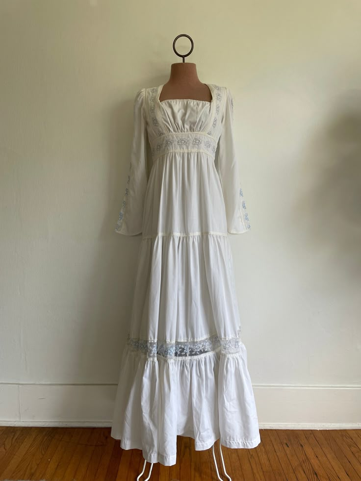 Beautiful gown, Gunne Sax label missing but I have seen this particular style more than twice.  Length: 55", Waist: 13.5" measured at rib from 14" drop from top hem Small stain at bust. Gimme Sax Wedding Dress, Gunne Sax Prom Dress, White 70s Dress, Cottagecore Square Neck Maxi Dress For Garden Party, Vintage Square Neck Maxi Dress For Garden Party, Fitted Square Neck Maxi Dress With Lace Trim, Cottagecore Maxi Prairie Dress For Garden Party, Cottagecore Maxi Vintage Dress For Garden Party, White Square Neck Prairie Dress Cottagecore Style