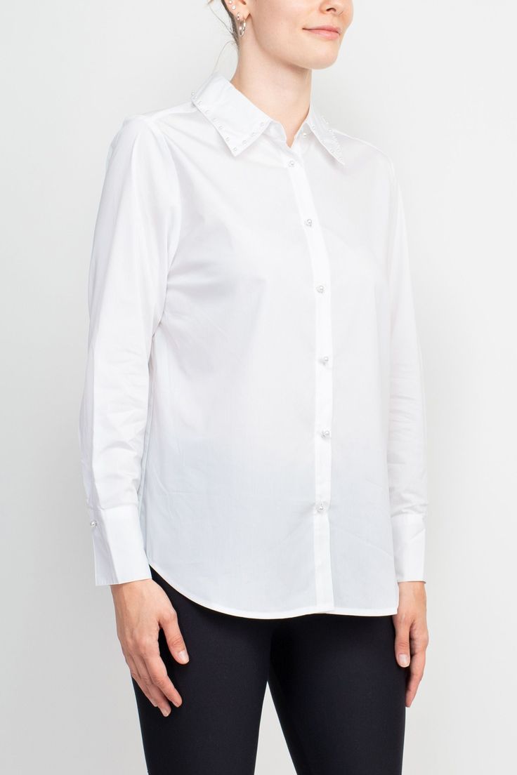 This Grand & Greene top is an opulent piece designed with exquisite pearl button detail. Crafted from lightweight rayon, it boasts a grand collar neck and long cuffs on the sleeves, perfect for a luxurious evening ensemble. Classic Blouse With Spread Collar And Covered Buttons, White Blouse With Embellished Collar For Work, Elegant Shirt With Button Closure For Daywear, Elegant Workwear Tops With Button Closure, Elegant Shirt With Collared Neckline And Placket, Formal Long Sleeve Shirt With Embellished Collar, Spring Shirt With Embellished Collar, Elegant Long Sleeve Shirt With Embellished Collar, White Long Sleeve Tops With Embellished Collar