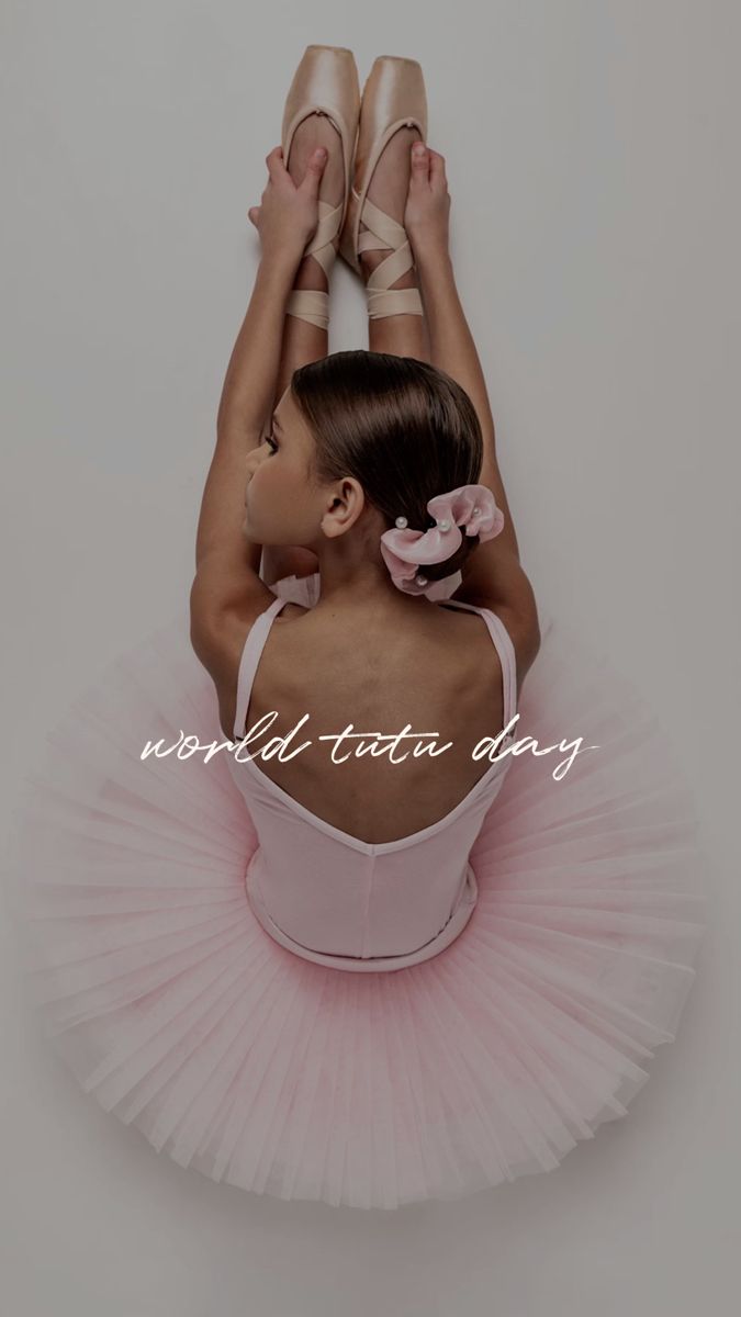 a young ballerina in pink tutu and ballet shoes with her hands behind her head