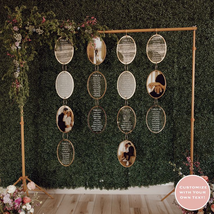 a wall with several pictures hanging from it's sides and flowers on the side