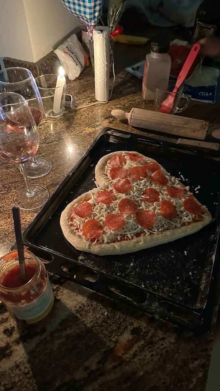 a heart shaped pizza sitting on top of a pan