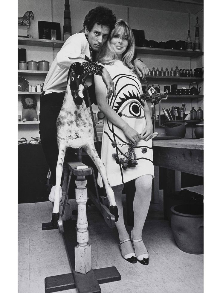 a man standing next to a woman in a kitchen