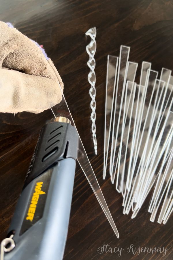 a pair of scissors and some wire on a wooden table with other items to be used