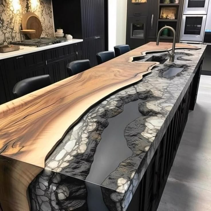 a kitchen counter with an unusual design on it's side and black cabinets in the background