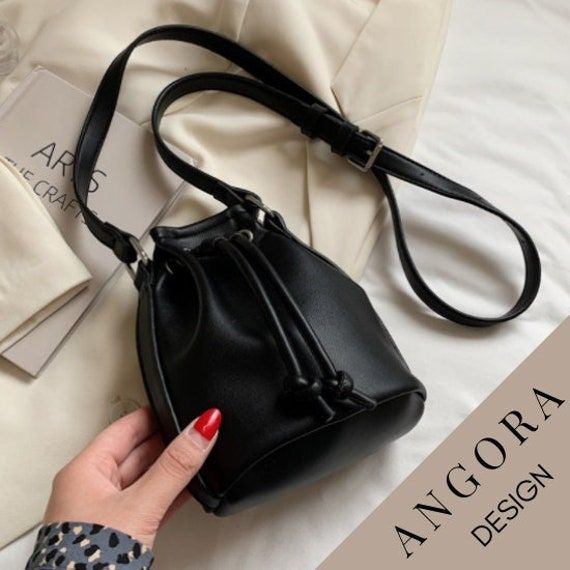 🎀 You will love this Minimal Casual Crossbody Bag that we produce from Leather! 🎀 This Mini Leather Bucket Bag specially designed for you will be indispensable for your outfit! 🎀 You can easily adjust the shoulder strap to the length you want. (Maximum 110cm = 43 Inches) 🎀 It is completely made of Synthetic leather, no animals were harmed in its production. 🎀 No chemicals harmful to health are used in the production of our products, we produce our products in the light of the sustainability Black Pouch Bucket Bag For School, Trendy Everyday Bucket Pouch, Black Bucket Pouch For Everyday Use, Trendy Drawstring Bag With Adjustable Strap For Daily Use, Black Pouch Phone Bag As Gift, Black Pouch Phone Bag Gift, Black Drawstring Bag For Daily Use, Daily Use Bucket Bag With Mobile Phone Pouch, Trendy Pouch Bucket Bag As Gift