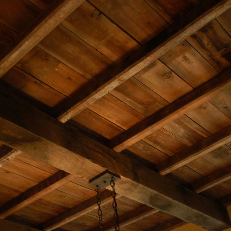 the ceiling is made of wood and has chains hanging from it's sides,