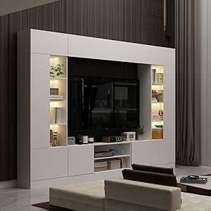 a modern living room with white furniture and dark wood paneling, along with a large flat screen tv mounted on the wall