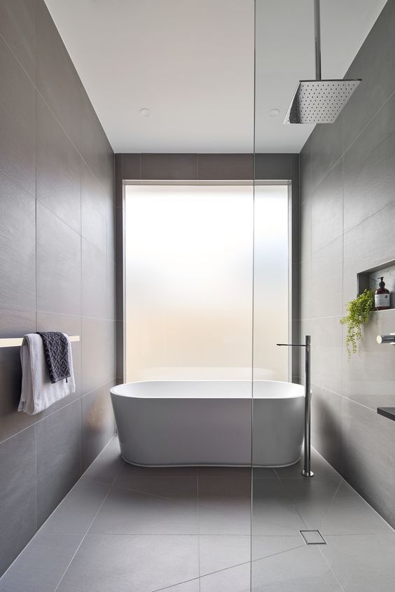 a bathroom with a bathtub, sink and towel rack on the wall next to it