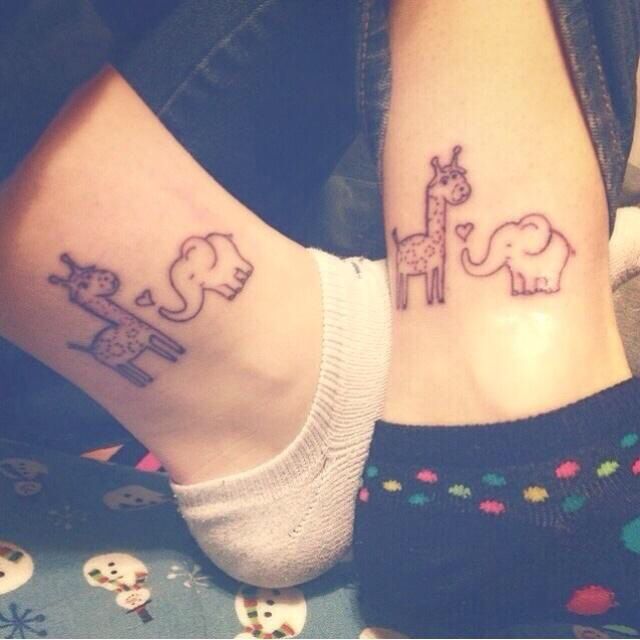 two people with matching tattoos on their feet, one has an elephant and the other has a giraffe