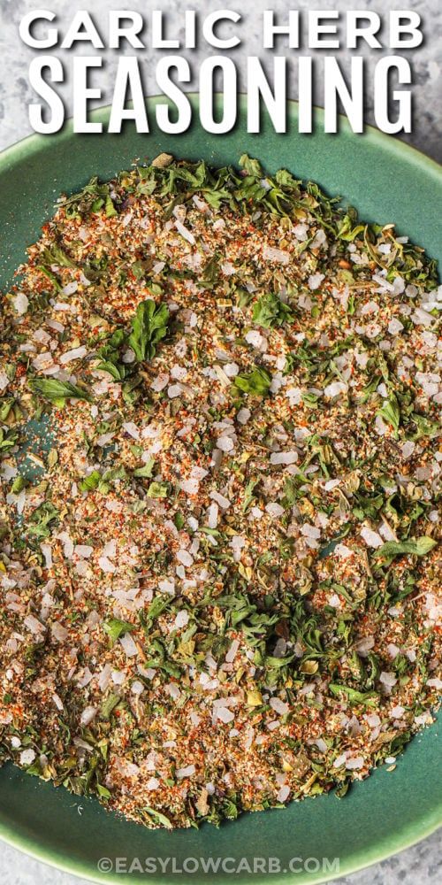 garlic herb seasoning in a green bowl with text overlay that reads garlic herb seasoning