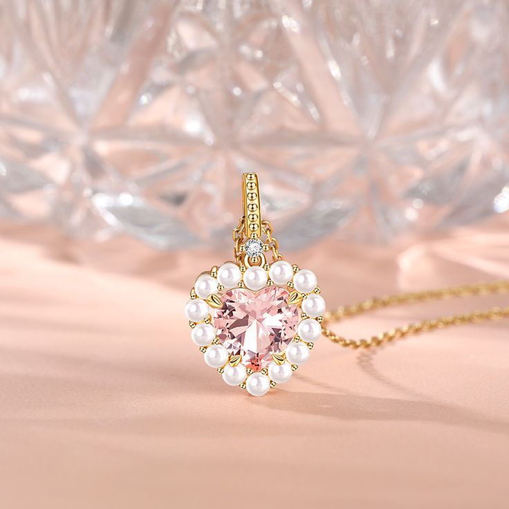 Wear this enchanting necklace as a reminder of the beauty and power of love. Let the soft pink hue of morganite evoke warmth and affection, while the heart-shaped design is a constant reminder of the love in your heart. Precisely crafted, this necklace features a heart-cut centre stone that sparkles against a halo of white pearls. The careful arrangement of these stones represents the harmony and balance found in true love.Carat Weight: 2.985 ctStone Size: 9*9 mmStone Type: Jeulia® StoneNumber o Heart-shaped Pearl Pendant Jewelry, Heart-shaped Pearl White Pendant Jewelry, Luxury Heart-shaped Pearl Pendant Jewelry, Heart-shaped Pink Pearl Necklace, Heart-shaped Diamond Accented Pendant Necklace For Valentine's Day, Round Necklace, Necklace Online, Pink Stone, Morganite