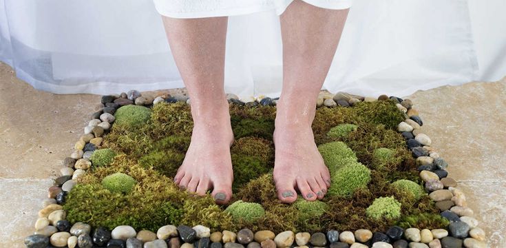 a person standing on top of a moss covered ground