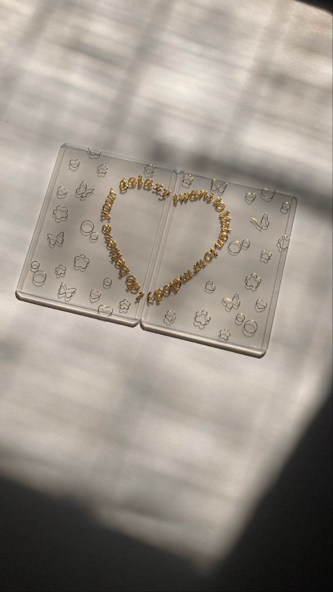 a heart shaped beaded necklace on top of a plastic tray