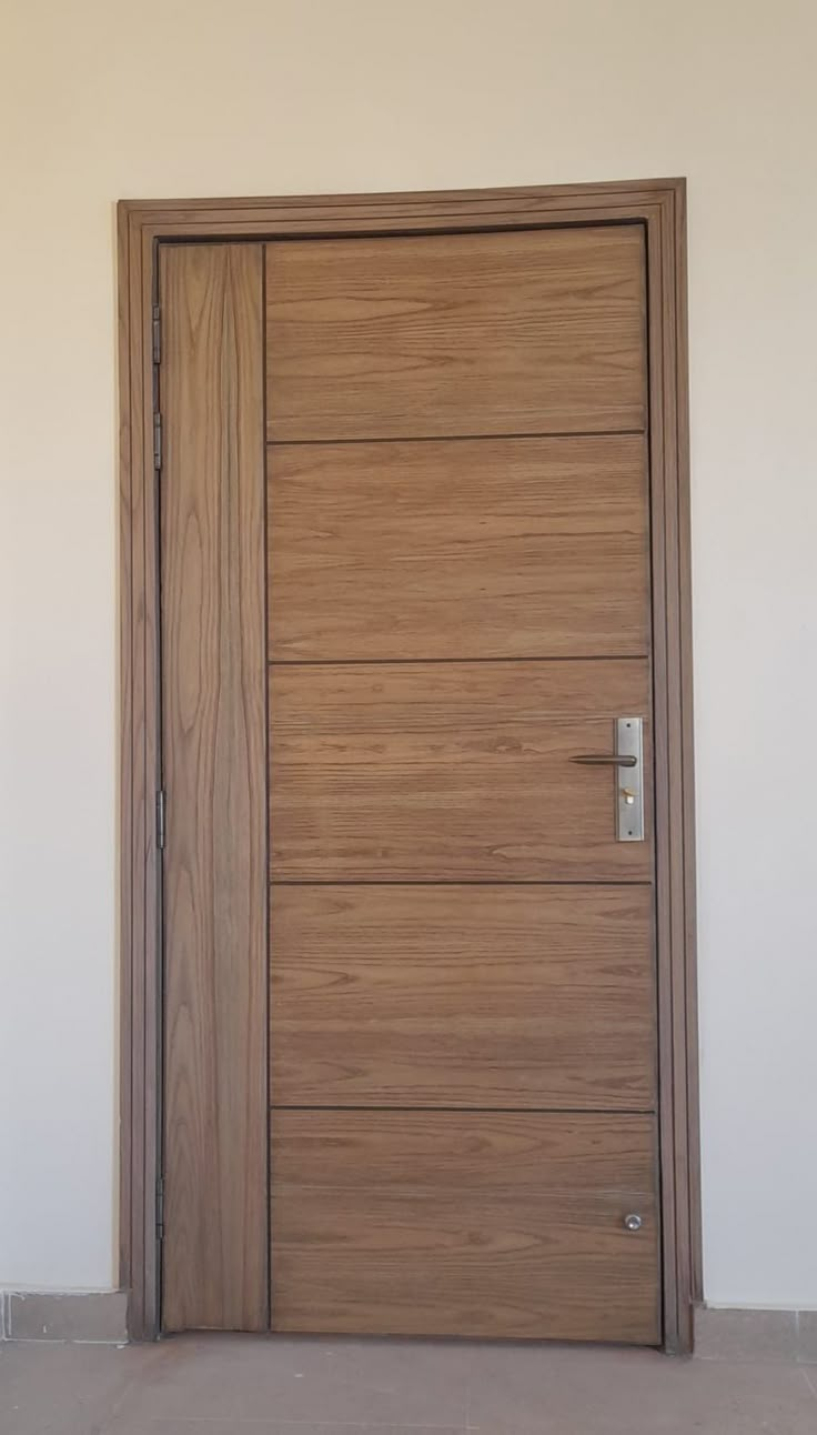 a wooden door in an empty room