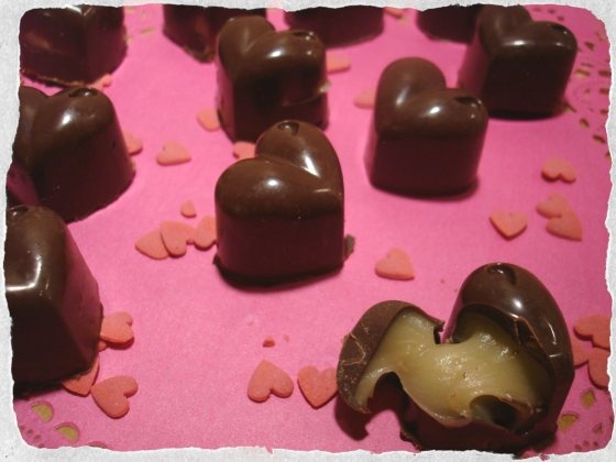 there are many heart shaped chocolates on the table