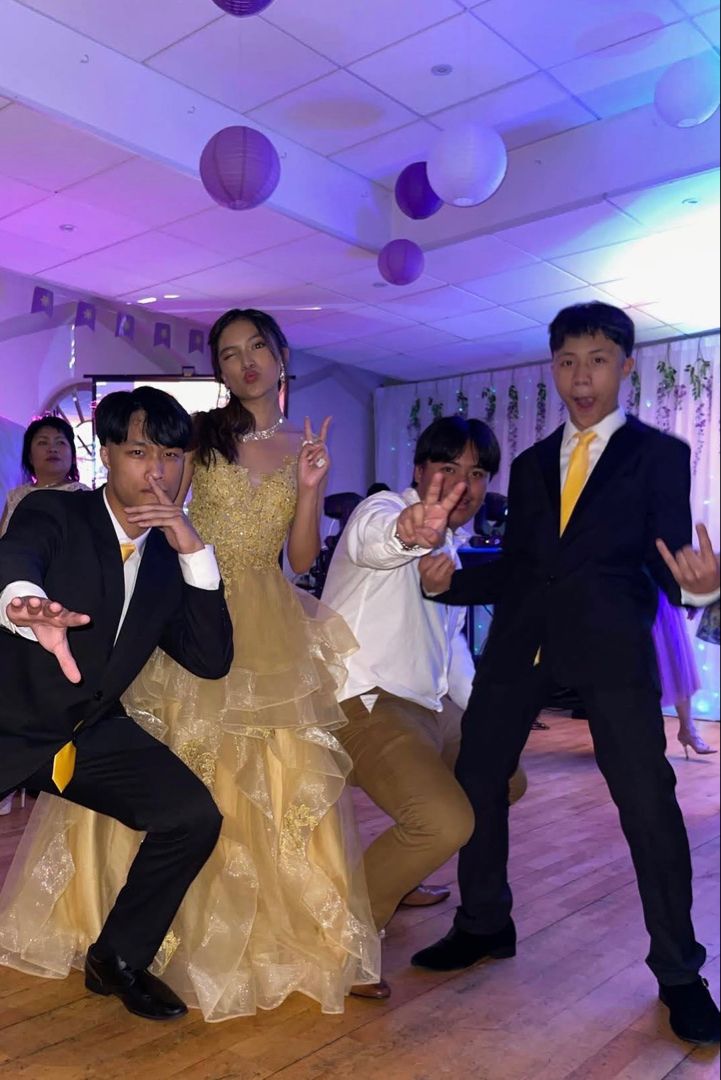 a group of people standing on top of a wooden floor in front of a dance floor