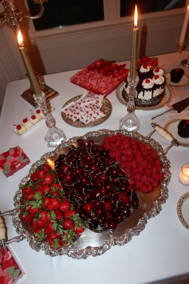 a table topped with lots of cakes and desserts