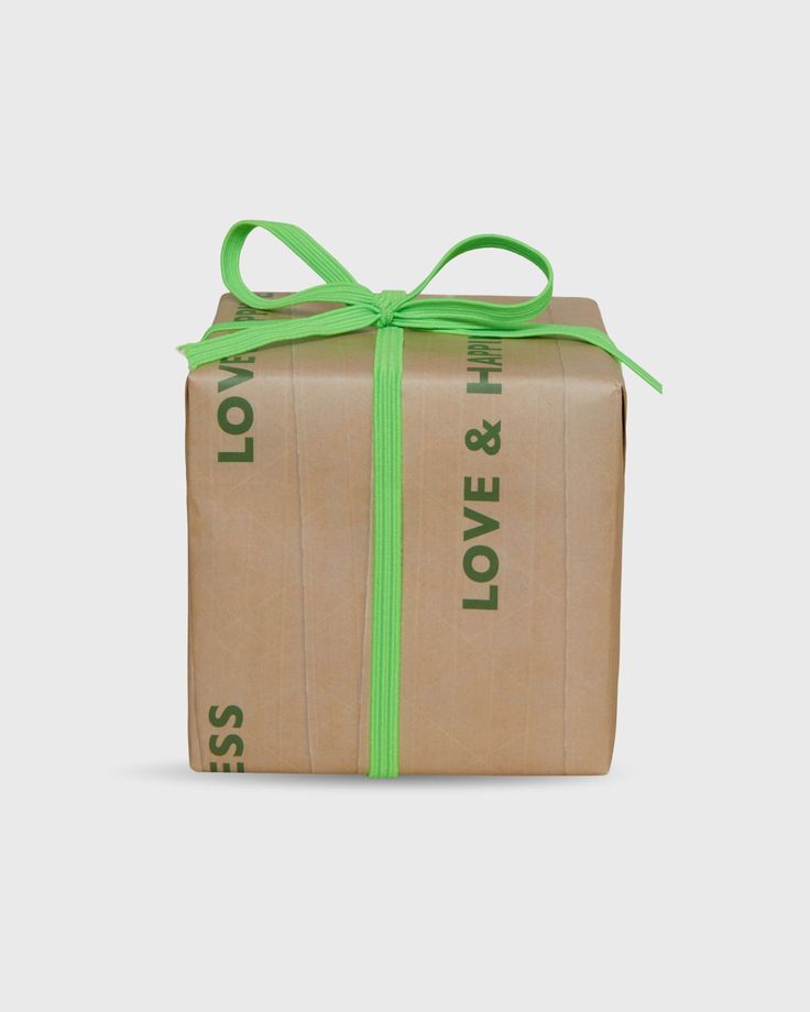 a wrapped gift box with green ribbon and love & lol logo on the side