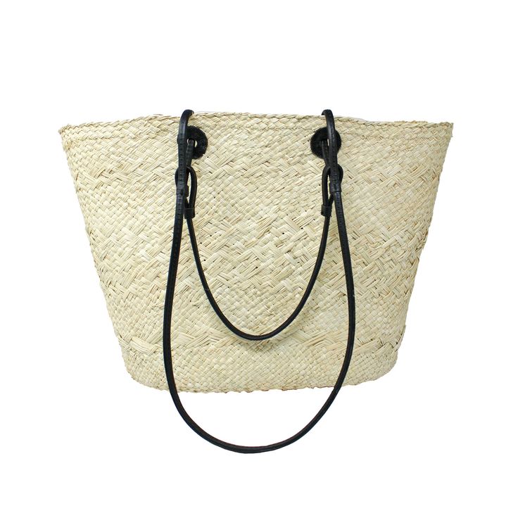 a white straw bag with black handles on the front and straps hanging from it's side