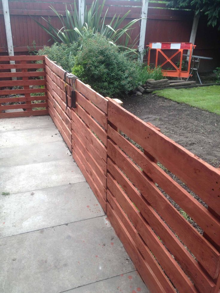 a wooden fence in front of a house