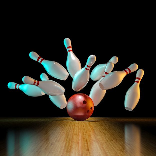 a bowling ball crashing into the pins on top of a bowling alley with skittles