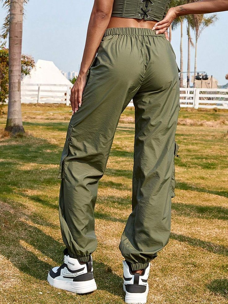 Make a fashion statement with our V Waist Zipper Detail Patched Jogger Cargo Pant. These pants feature a unique V waist design and zipper details that add a touch of contemporary style. The patched accents enhance the overall visual interest. Made from comfortable and durable fabric, these jogger cargo pants offer a perfect combination of fashion and functionality. Specification: Style: Casual Pattern Type: Plain Type: Cargo Pants Details: Drawstring, Pocket Waist Line: Drop Waist Length: Long F Trendy Streetwear Pants With Zipper Closure, Sporty Nylon Bottoms With Zipper Closure, Trendy Trousers With Zipper Closure, Sporty Fitted Bottoms With Zipper Closure, Sporty Streetwear Pants With Zipper Closure, Trendy Stretch Cargo Parachute Pants, Utility Parachute Pants With Zipper For Streetwear, Trendy Trousers With Zip Fly, Casual Pants With Zipper Pocket For Fall