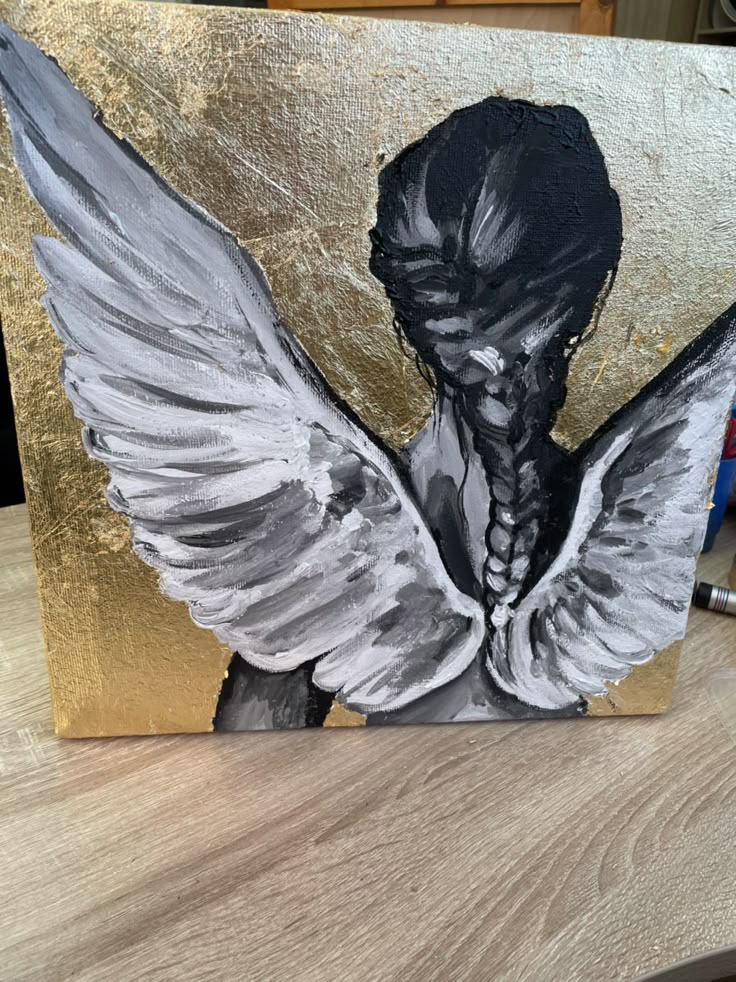 an acrylic painting of a woman's head with wings painted on it