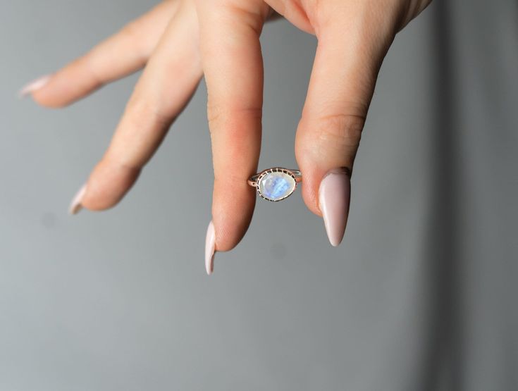 One of a kind faceted dainty ring with genuine Rainbow Moonstone gemstone.  These beautiful rainbow moonstones have a rainbow iridescence and the photos do not do justice to show its holographic color. Made of solid 925 sterling silver. ❥ Metal: Solid sterling silver ❥ Gemstone: Rainbow Moonstone  ❥ Gemstone Color: Blue  ✈ Free Shipping (USPS) 🎁 Every package is luxury gift wrapped which includes a microfiber cleaning cloth, microfiber reusable jewelry pouch, jewelry care card and more! ⌛ 24 ho Moonstone Stackable Rings For Gifting, Moonstone Gemstone Stackable Rings As Gift, Moonstone Ring As A Gift, Moonstone Ring For Gift, Moonstone Stackable Rings For Gift, White Moonstone Stackable Rings Gift, Dainty Moonstone Stackable Rings For Gift, Dainty Moonstone Stackable Rings As Gift, Oval Moonstone Stackable Rings As Gift