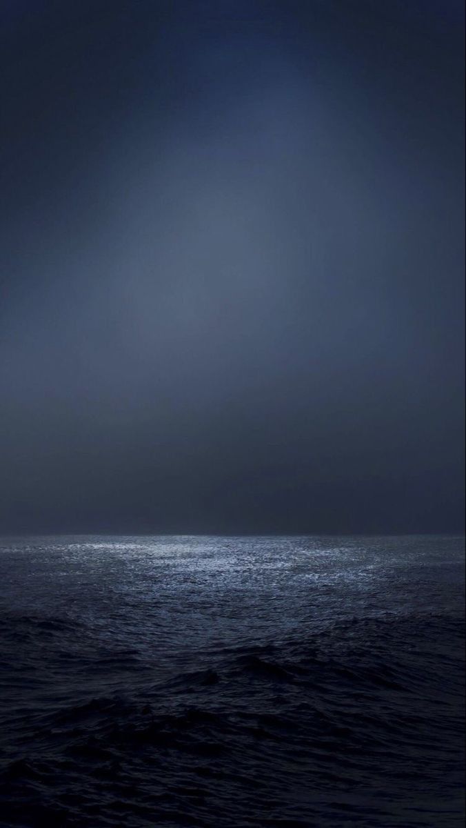 the ocean is very dark and it looks like something from another place in the world