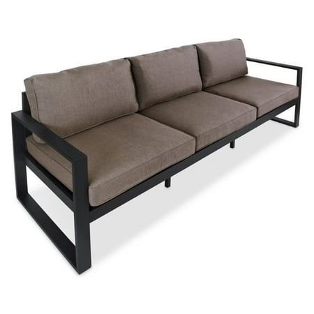 a black and brown couch sitting on top of a white floor