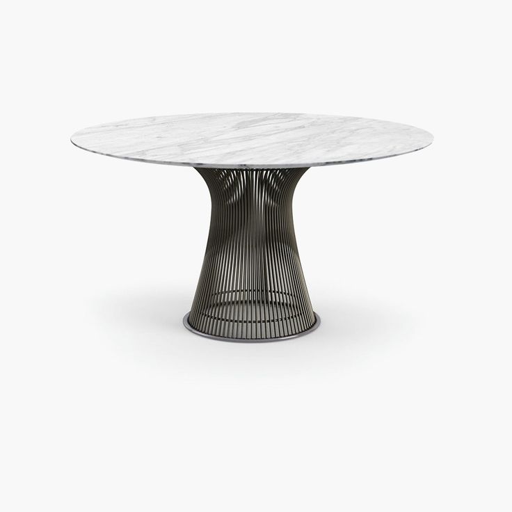 an oval marble dining table with black metal base and wavy lines on the top, against a white background