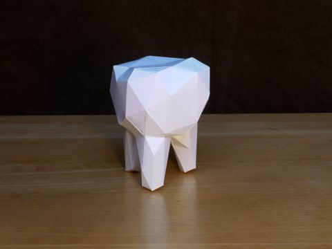 an origami elephant on a wooden table