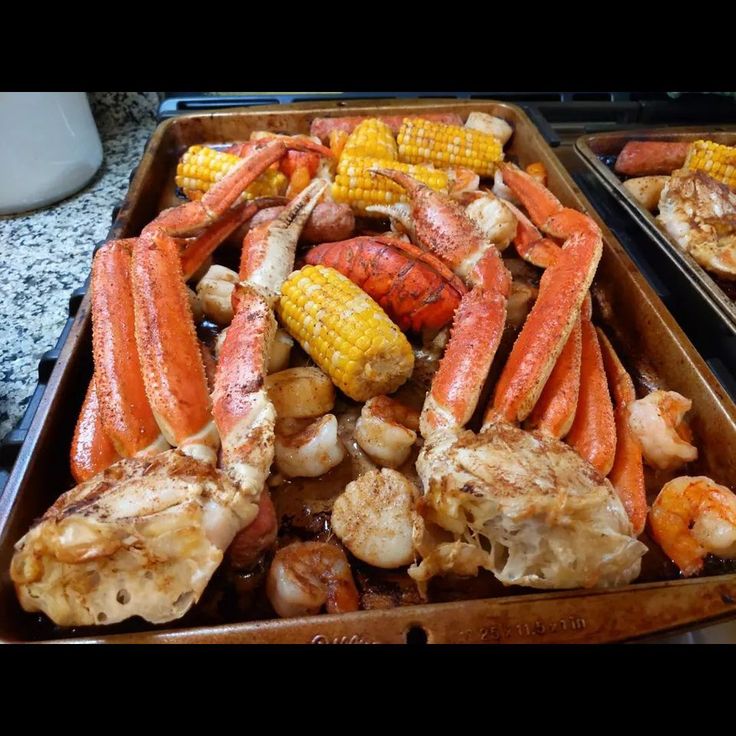 crab legs and corn on the cob are served in trays