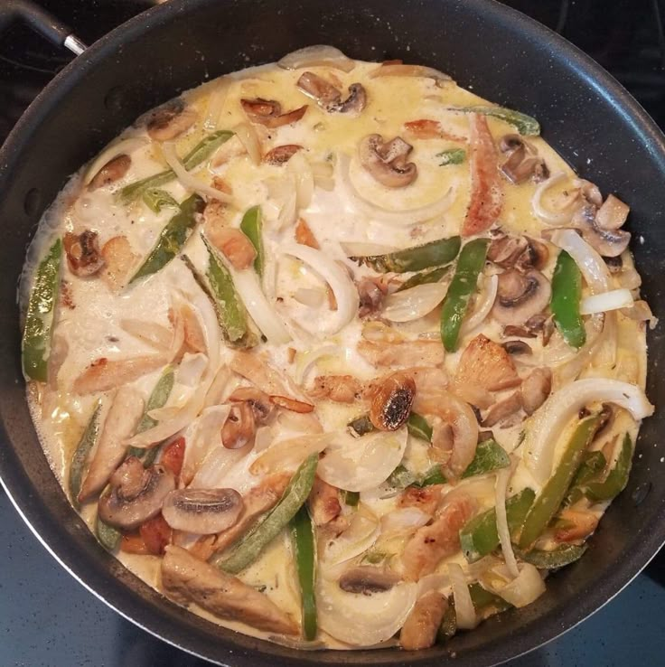 a pan filled with food sitting on top of a stove