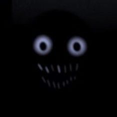 a creepy looking face in the dark