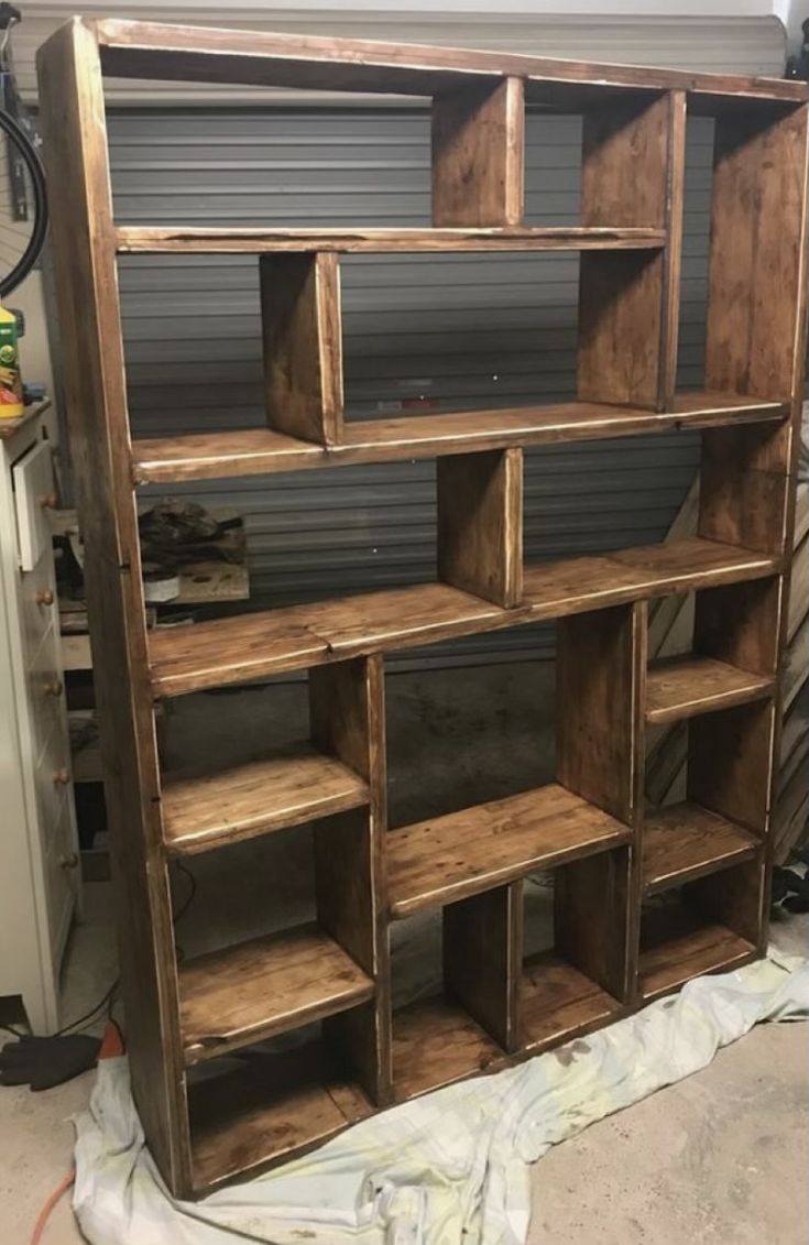 the shelves are made out of wood and ready to be painted