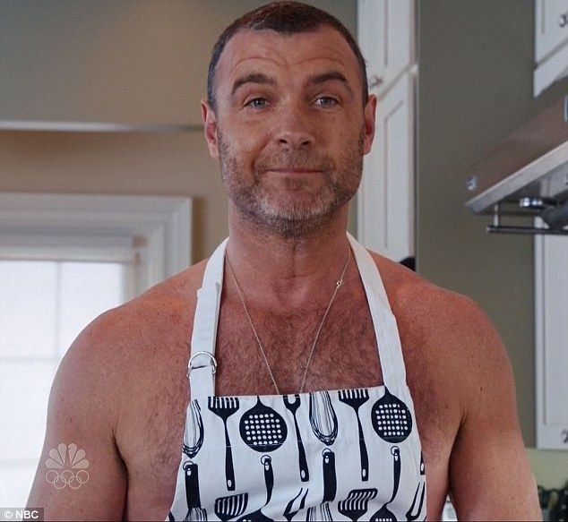 a man with an apron on in the kitchen